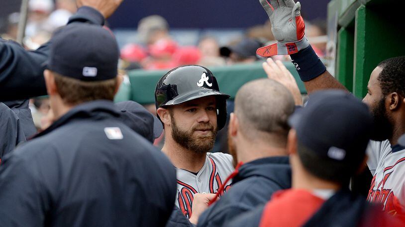 Atlanta Braves catcher Evan Gattis (24), center, is congratulated in the dugout following his solo home run against the Washington Nationals in the fifth inning at Nationals Park in Washington, D.C., Friday, April 4, 2014. The Braves defeated the Nationals, 2-1. (Chuck Myers/MCT)