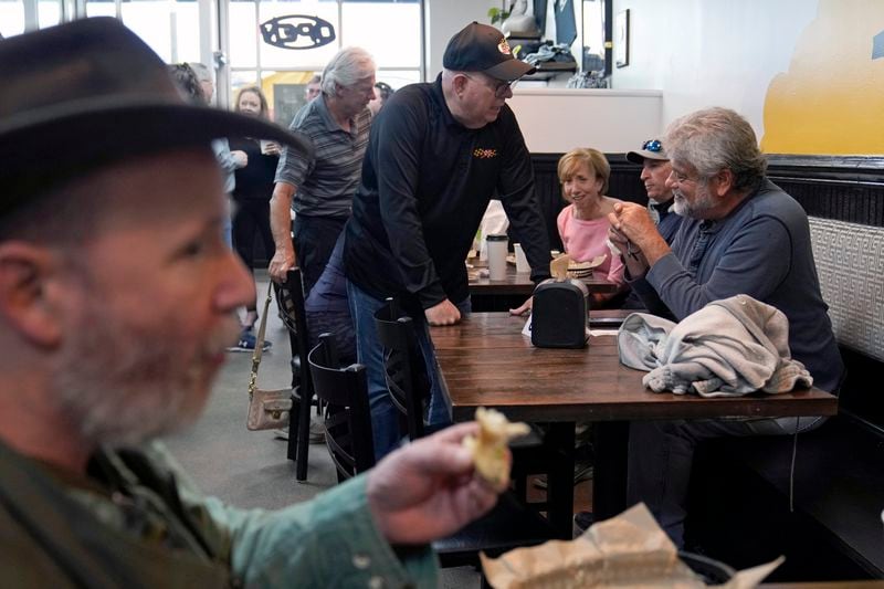 Former Maryland Gov. Larry Hogan, center, talks with patrons of DePaola's Bagel and Brunch in Stevensville, Md., Friday, April 12, 2024, as he campaigns for the U.S. Senate. (AP Photo/Susan Walsh)