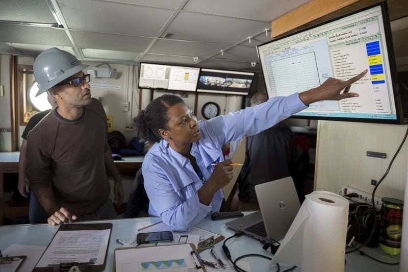 SAVANNAH, GA - OCTOBER 23, 2019: University of Georgia research assistant Tina Walters, center, and marine technician Vinay Arora, left, look at the latest water, sediments and plankton sample drawn from the commercial fishing grounds in Wassaw Sound. (AJC Photo/Stephen B. Morton)