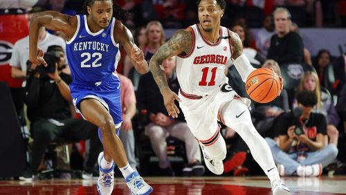 Georgia guard Justin Hill (11) brings the ball up the floor in a recent game against Kentucky. The Bulldogs are looking to win their first road game since beating Ole Miss on Jan. 14 in Oxford when they visit Arkansas on Tuesday night. (AP file photo/Alex Slitz)
