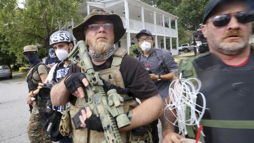 Counter protesters face off with protesters as several far-right groups, including militias and white supremacists, rally Saturday, Aug. 15, 2020, in Stone Mountain, Georgia, while a broad coalition of leftist anti-racist groups organized a counter-demonstration. (Jenni Girtman/Atlanta Journal-Constitution/TNS)