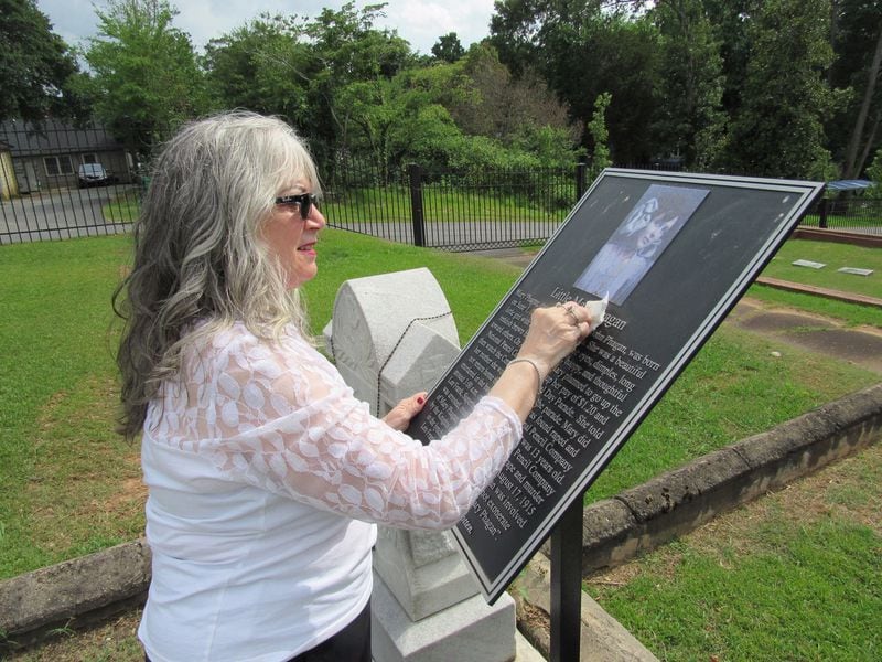 Mary Phagan-Kean cleans a marker at the resting place of her great-aunt and namesake, Mary Phagan. Photo: Jennifer Brett