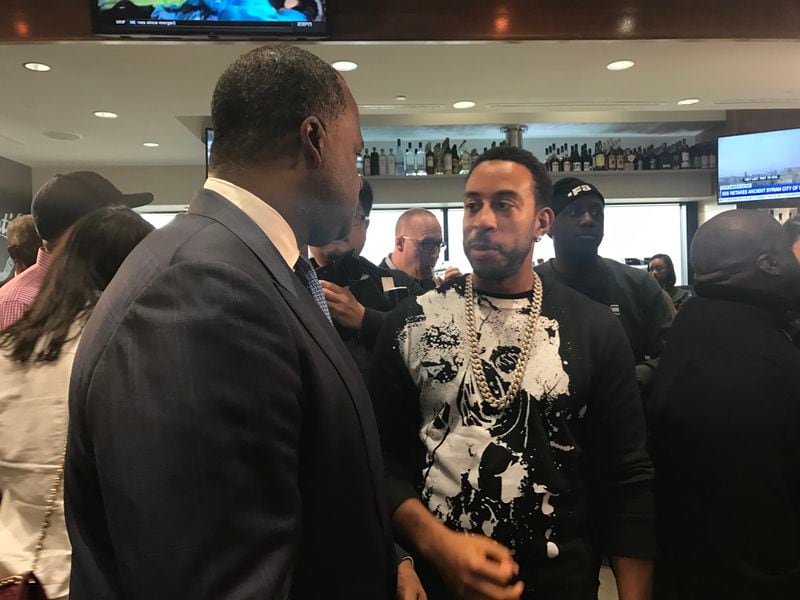 Atlanta Mayor Kasim Reed, left, speaks with Ludacris at the ribbon-cutting celebration for Chicken + Beer