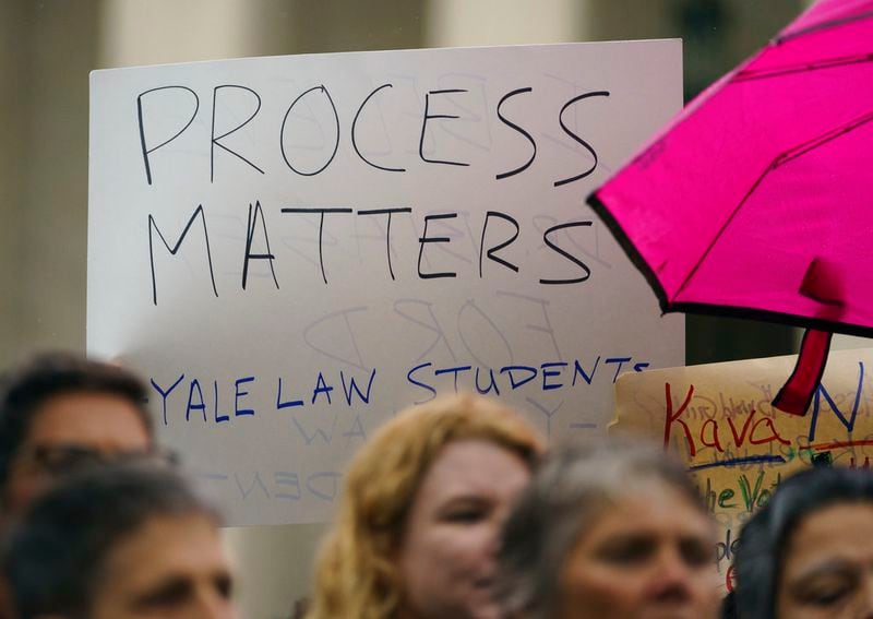 A protester holds a sign that reads "Process Matters Yale Law Students" in front of the Supreme Court on Capitol Hill in Washington, Monday, Sept. 24, 2018. A second allegation of sexual misconduct has emerged against Judge Brett Kavanaugh, a development that has further imperiled his nomination to the Supreme Court, forced the White House and Senate Republicans onto the defensive and fueled calls from Democrats to postpone further action on his confirmation. President Donald Trump is so far standing by his nominee. (AP Photo/Carolyn Kaster)