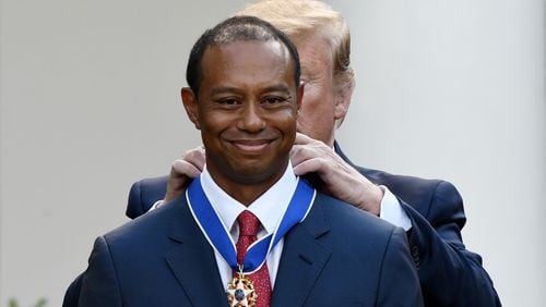 Tiger Woods happily receives the nation's highest civilian honor, the Presidential Medal of Freedom, during a ceremony in the Rose Garden at the White House. (Olivier Douliery/Abaca Press/TNS)