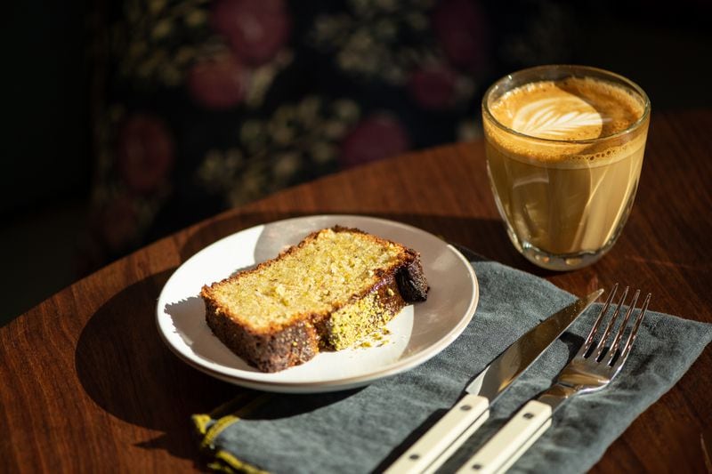 Le Bon Nosh's pistachio cake and a latte. (Mia Yakel for The Atlanta Journal-Constitution)