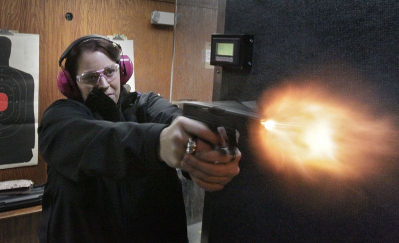  Sydni Lee fires her Glock 19 at a gun range in Cumming in 2013. BOB ANDRES BANDRES@AJC.COM