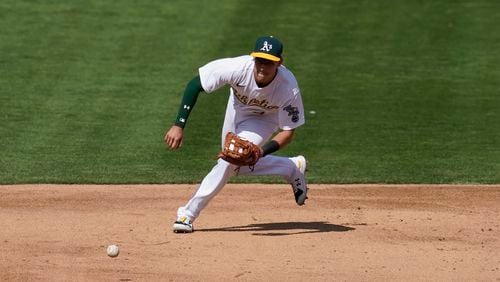Oakland Athletics' Jake Lamb makes a play of the ball against the San Francisco Giants Saturday, Sept. 19, 2020, in Oakland, Calif. (Jeff Chiu/AP)