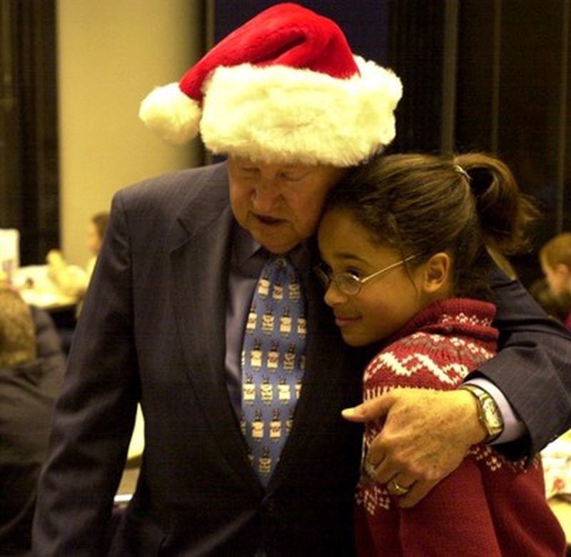 Truett Cathy at a 2002 Christmas party for foster children at the Chick-fil-A corporate headquarters. AJC file photo/W.A. Bridges