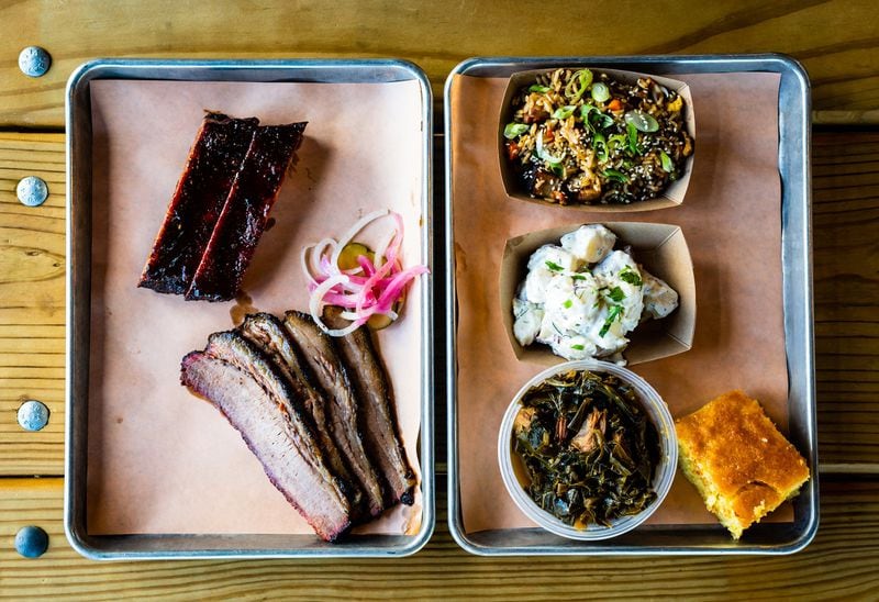 A two-meat plate of St. Louis-style pork ribs and beef brisket with three sides and cornbread.. The two-meat plate typically includes two sides. CONTRIBUTED / HENRI HOLLIS