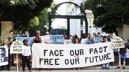 Current and former University of Georgia students, faculty and community activists gather at the Arch ahead of their march toward Baldwin Hall on May 6, 2019, in Athens. The demonstrators have pushed the school to offer various forms of reparations to address how, they say, the university has taken advantage of descendants of enslaved peoples, pay a higher working wage for university employees and give justice to the slaves who were found buried below Baldwin Hall. CONTRIBUTED BY CHRISTINA R. MATACOTTA