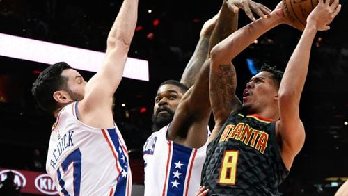 Hawks guard Damion Lee (8) shoots as Philadelphia 76ers guard JJ Redick (17) and center Amir Johnson defend during the first half of an NBA basketball game Tuesday, April 10, 2018, in Atlanta. (AP Photo/John Amis)