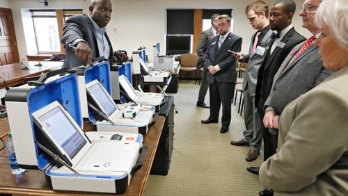 1/15/19 - Atlanta - Dwayne Broxton (left), Regional Sales Director for Hart InterCivic, demonstrates his companies' voting machines to lawmakers. Bob Andres / bandres@ajc.com