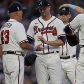 Braves pitcher Drew Smyly (center) hands the ball to manager Brian Snitker (43) in the sixth inning of the second game of a doubleheader against the St. Louis Cardinals, Sunday, June 20, 2021, at Truist Park in Atlanta. (Ben Margot/AP)