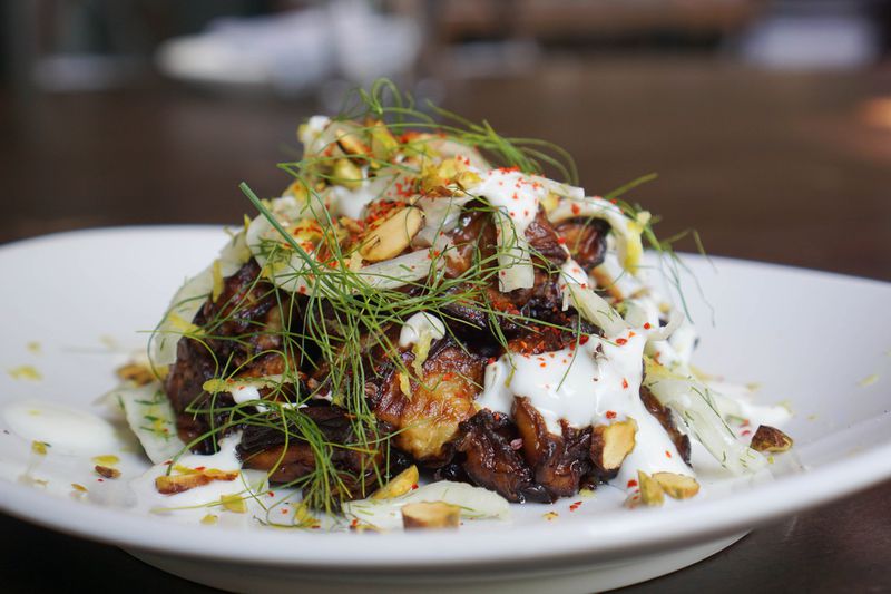 Salad selections on Saltyard’s debut lunch menu include charred eggplant mounded with shaved fennel and flecked with feta, mint, toasted pistachios, lemon zest, Korean red pepper flakes known as gochugaru, and a buttermilk yogurt dressing. CONTRIBUTED BY SALTYARD