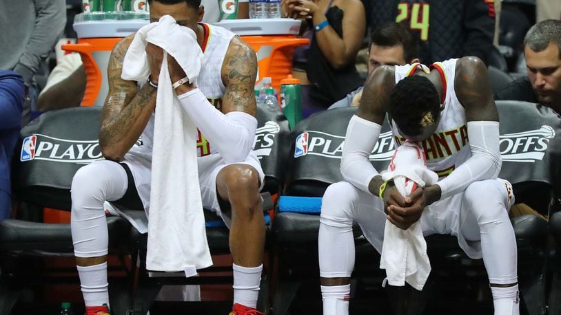 Hawks players Kent Bazemore and Dennis Schroder sit dejected on the bench in the final minute of a 115-99 playoff loss to the Washington Wizards Friday night at Philips Arena. The Hawks lost the first-round series, four games to two. (Curtis Compton/ccompton@ajc.com)