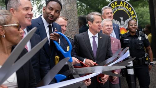 220629-Atlanta-Atlanta Mayor Andre Dickens and Gov. Brian Kemp get their ceremonial scissors ready during a ribbon-cutting for a new police mini-precinct in Buckhead Village on Wednesday, June 29, 2022.  Ben Gray for the Atlanta Journal-Constitution