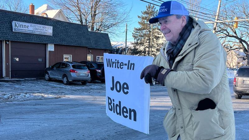 Bob Mulholland waving a “Write-in Joe Biden” sign on Hooksett Road in Manchester, New Hampshire.