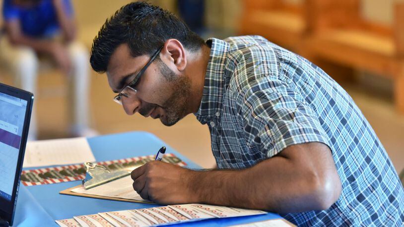 Mehbs Omar registers to vote during Friday Prayers at Madina institute, Islamic educational institution, in Duluth on Friday, September 9. HYOSUB SHIN / HSHIN@AJC.COM