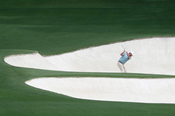 April 9, 2021, Augusta: Marc Leishman hits his second shot in the fairway bunker on the eighth hole during the second round of the Masters at Augusta National Golf Club on Friday, April 9, 2021, in Augusta. Curtis Compton/ccompton@ajc.com