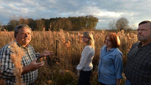 Jeff DeFoor (left) talks with his daughter Kaitlin DeFoor (second from left) and brother and his wife Dan and Mary DeFoor near his property and proposed pipeline route in Resaca.  The line would help bring in gas from fracking fields in other parts of the nation. But DeFoor and his family fear a potential safety and environmental hazard.