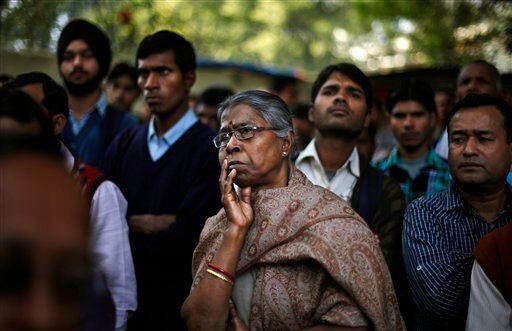 Indian people listen to a speaker, unseen, while they participate in a protest against a new sexual violence law as the parliament convenes in New Delhi, India.