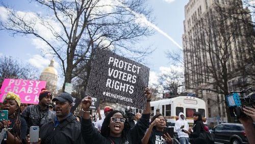 People march during a downtown Atlanta protest Friday. Another march is scheduled for Saturday. BRANDEN CAMP / SPECIAL