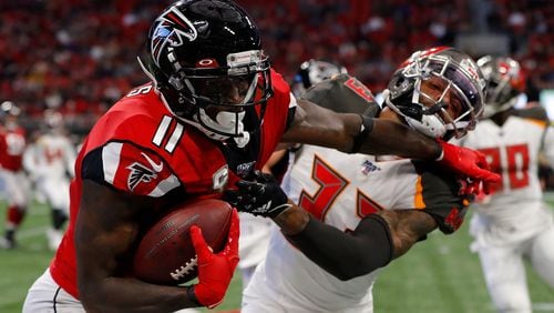 Falcons wide receiver Julio Jones stiff arms Tampa Bay's Carlton Davis after a reception in the first half Sunday, Nov. 24, 2019, at Mercedes-Benz Stadium in Atlanta.