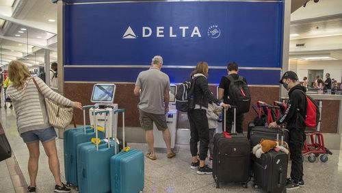 06/15/2021 — Atlanta, Georgia — Delta Air Lines patrons check-in at the electric kiosk during an early morning at Hartsfield-Jackson Atlanta International Airport, Tuesday, June 15, 2021. (Alyssa Pointer / Alyssa.Pointer@ajc.com)