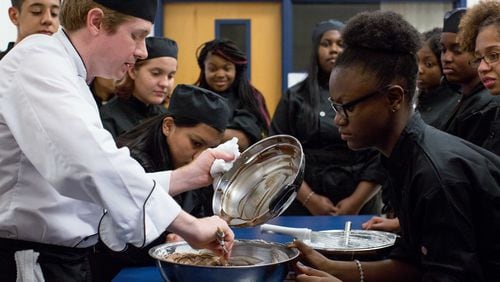Mundy’s Mill High Schoo teacher Kenneth Hosley pours chocolate into a bowl during a cooking class, in this 2016 file photo. Clayton County Schools begin Aug. 7 for the 2017-18 school year.