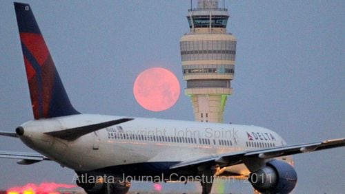 110418 Atlanta: A pink April moon loomed over the Hartsfield-Jackson International Airport control tower Monday, April, 18, 2011. John Spink jspink@ajc.com