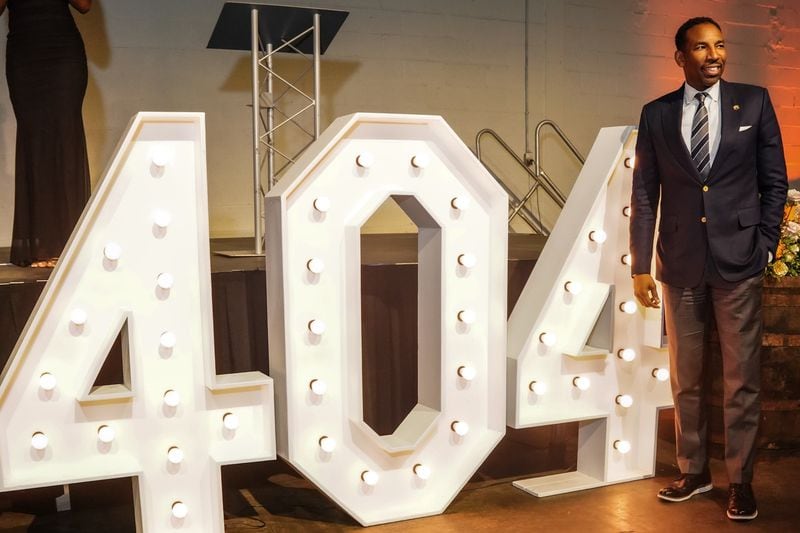 Mayor Andre Dickens poses in front of a large "404" display at a scholarship gala raising funds for Atlanta students on April 3, 2024.
