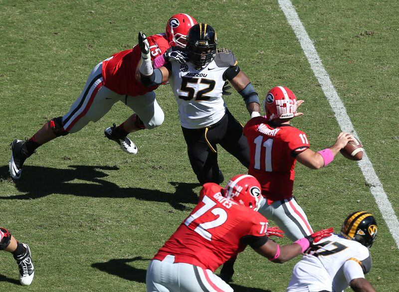 October 12, 2013 - Athens, Ga: Missouri Tigers defensive lineman Michael Sam (52) puts pressure on Georgia Bulldogs quarterback Aaron Murray (11) as Georgia Bulldogs offensive tackle Kolton Houston (75) attempts to block during their game at Sanford Stadium Saturday afternoon in Athens, Ga., October 12, 2013. Missouri defeated Georgia 41-26. Murray threw for 290 yards, 3 touchdowns, 2 interceptions and had a fumble returned for a touchdown in the loss. JASON GETZ / JGETZ@AJC.COM Michael Sam rushes Aaron Murray. (Jason Getz/AJC)
