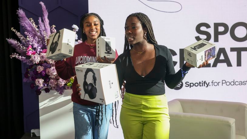 Spelman students Janay Trench-Lesley, left, and Anna-Prin Sido, pose with their head phones and microphones they received after they volunteered on stage during Spelman Creator Day at the Wellness Center Gymnasium at Spelman College, Monday, March 20, 2023, in Atlanta. Creator Day is an audio event including influencers Rickey Thompson, Denzel Dion, and Wunmi Bello. Spelman is the first HBCU to partner with Spotify for its NextGen program. Jason Getz / Jason.Getz@ajc.com)