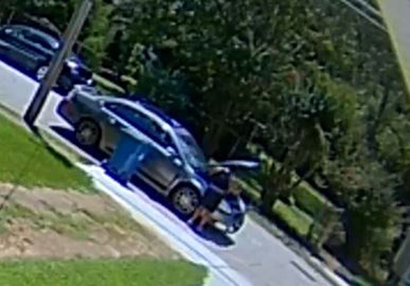 A woman is shown in surveillance video looking under the hood of a Chevrolet Impala in the area of Dorsey Avenue on Wednesday afternoon. East Point police believe she later broke into a 67-year-old woman’s home and assaulted her before stealing her debit card. 