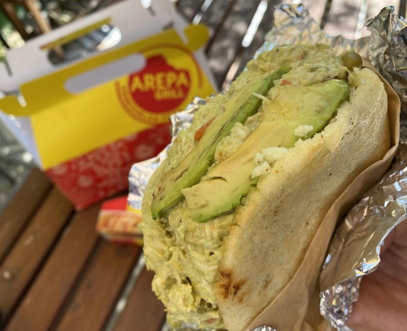 The Reyna Pepiada arepa from Arepa Grill is filled with shredded chicken, avocado and mayonnaise. Ligaya Figueras / ligaya.figueras@ajc.com