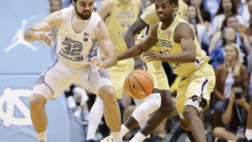 North Carolina's Luke Maye (32) and Georgia Tech's Curtis Haywood II chase the ball during the second half of an NCAA college basketball game in Chapel Hill, N.C., Saturday, Jan. 20, 2018. North Carolina won 80-66. (AP Photo/Gerry Broome)