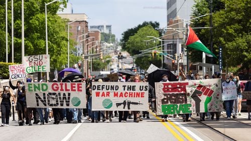 Pro-Palestinian protestors march to end the GILEE program, which sends local police to train in Israel, in Atlanta on Friday, May 3, 2024. (Arvin Temkar / AJC)