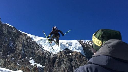 This photo taken from a 4K video and dated Wednesday, Oct. 18, 2017 shows a skier performing a jump during training on the glacier above Saas-Fee, Switzerland. The glacier attracted skiers and snowboard athletes from an array of nations, who came hunting for snow on which to train early in the season ahead of the 2018 Pyeongchang Olympics. (AP Photo/John Leicester)
