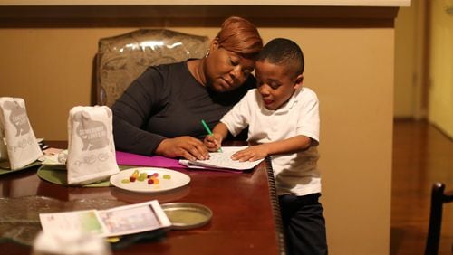 Tomeka Gadson works on homework with her grandson Jeremy Bacote, 5, at her home in Southeast Atlanta. Gadson is critical of Atlanta Public School’s disciplinary policy after Bacote had problems at school. Ben Gray / bgray@ajc.com