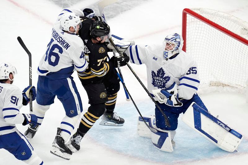 Toronto Maple Leafs' Ilya Lyubushkin (46) defends against Boston Bruins' Charlie McAvoy (73) in front of Ilya Samsonov (35) during the first period of Game 7 of an NHL hockey Stanley Cup first-round playoff series, Saturday, May 4, 2024, in Boston. (AP Photo/Michael Dwyer)