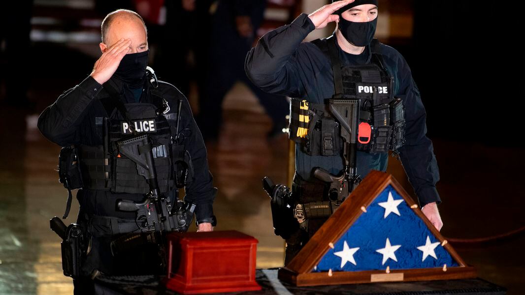 Members of the Capitol Police pay respects to the remains of U.S. Capitol Police Officer Brian Sicknick as he lies in honor in the Rotunda of the U.S. Capitol in February. Sicknick died after being injured in the Jan. 6 attack by rioters supporting then-President Donald Trump. (Brendan Smialowski/Pool/AFP via Getty Images/TNS)