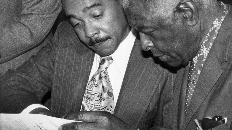 Alonzo Crim (left), former superintendent of Atlanta Public Schools, confers with Dr. Benjamin Mays in this photo taken in the early 1970s. (AJC STAFF / FILE PHOTO)
