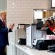 Republican presidential candidate former President Donald Trump, left, speaks to employees as he visits a Chick-fil-A eatery, Wednesday, April 10, 2024, in Atlanta. (AP Photo/Jason Allen)