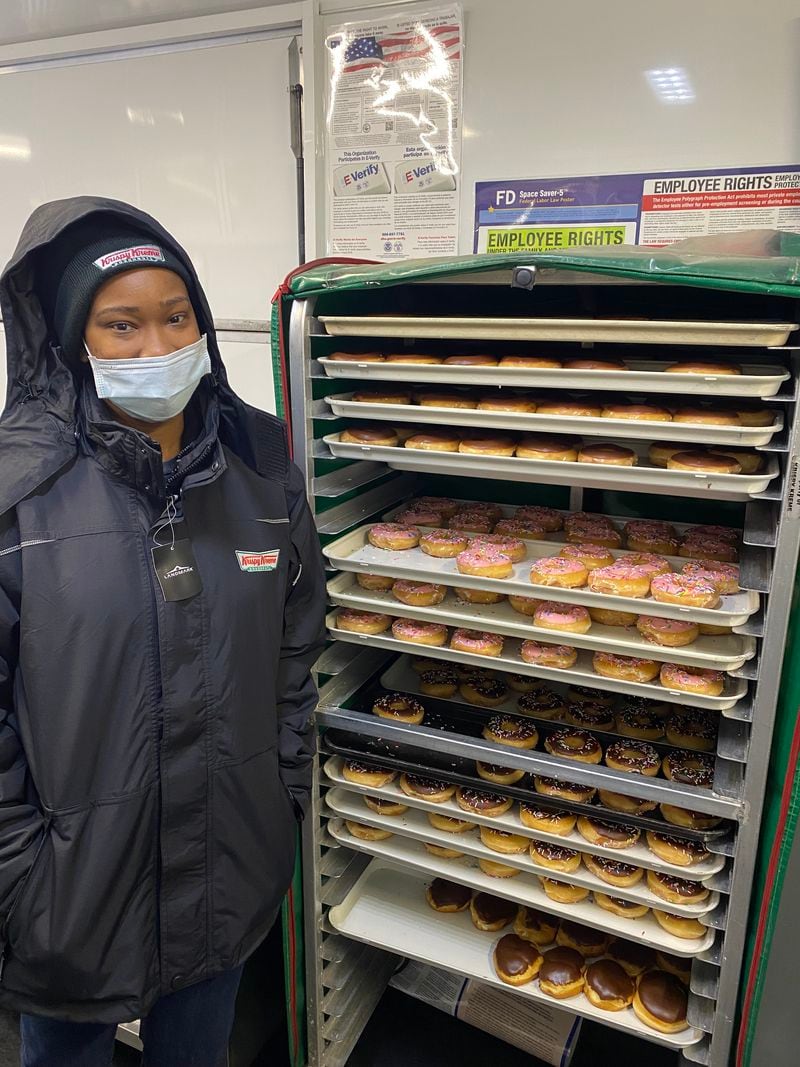 Tiara Smith worked at the Ponce de Leon Avenue Krispy Kreme from 2017 to 2019. She recently returned to work at the temporary drive-through pop-up. Ligaya Figueras/ligaya.figueras@ajc.com