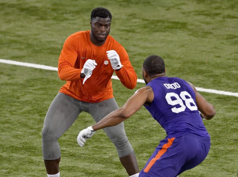 Shaq Lawson, back, and Kevin Dodd run drills at Clemson's NFL football Pro Day Thursday, March 10, 2016, in Clemson, S.C. (AP Photo/Richard Shiro)
