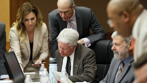 Tex McIver (seated) is surrounded by attorneys Amanda Clark Palmer, Bruce Harvey, Don Samuel (seated, to McIver’s left) and Clint Rucker as they review questions wants to ask of a witness. Bob Andres / bandres@ajc.com