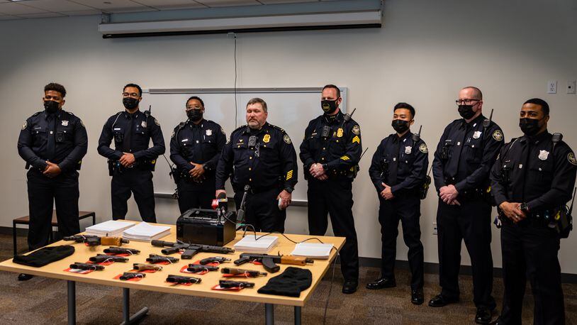 The officers of the Tactical Traffic Crime Reduction Unit in the Atlanta Police Department's Zone 5 gather with Lt. Jeff Childers (center).