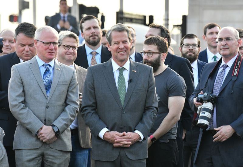 Georgia Governor Brian Kemp smiles during a press conference at Liberty Plaza across from the Georgia State Capitol in Atlanta on Thursday, December 16, 2021. Electric vehicle maker Rivian on Thursday confirmed its plans to build a $5 billion assembly plant and battery factory in Georgia, which Gov. Brian Kemp called "the largest single economic development project ever in this state's history." (Hyosub Shin / Hyosub.Shin@ajc.com)