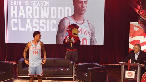 Hawks second-year forward John Collins models a throwback uniform from 1968 that the team will wear several times this season.